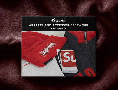 Red apparel and accessories, including a beanie and a jacket, are displayed on a textured surface. With promotional text, "Kenshi Apparel and Accessories 15% Off," this vibrant collection showcases the artistry you'd expect from a leading Toronto Design Agency like Conte Studios. Conte Studios