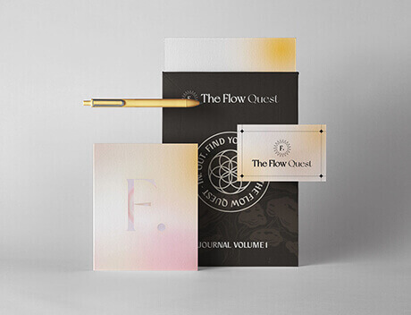 A gold pen, journal, business card, and pamphlet are arranged against a light gray background. The journal is labeled with "F." The pamphlet reads "The Flow Quest Journal Volume I," a creation of a leading Brand Design Agency Toronto. Conte Studios