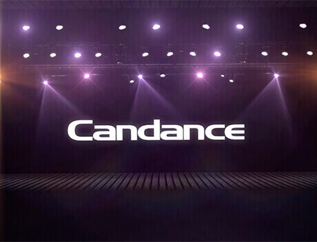 A stage is illuminated with purple lights, displaying the word "Candance" in large white letters, capturing the creative brilliance of a brand design agency in Toronto. Conte Studios