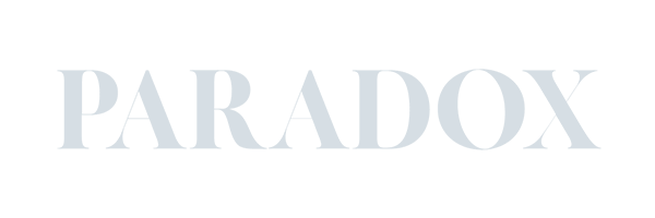 The image displays the word "PARADOX" in large, light gray capital letters against a dark background, reminiscent of the creative edge found at Conte Studios, a leading brand design agency in Toronto. Conte Studios