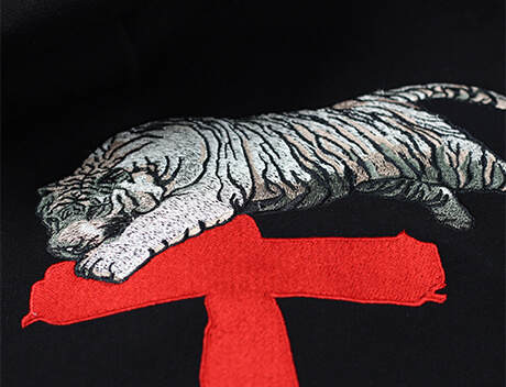 Illustration of a white tiger resting on a red cross-shaped platform on a black background, reflecting the creative flair of a Toronto design agency. Conte Studios